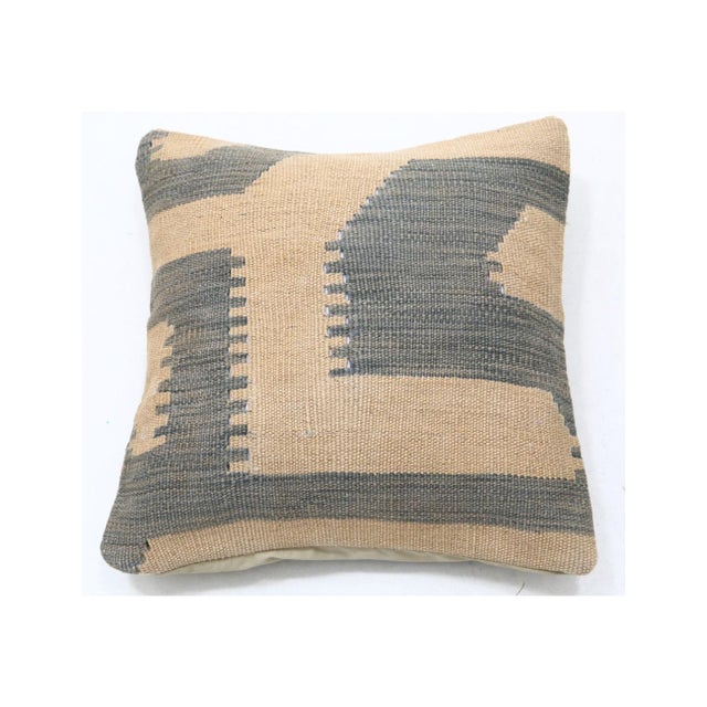 This sand and slate gray geometric color-block kilim throw pillow by Arteverk measures 17 x 17 inches, with a handwoven...