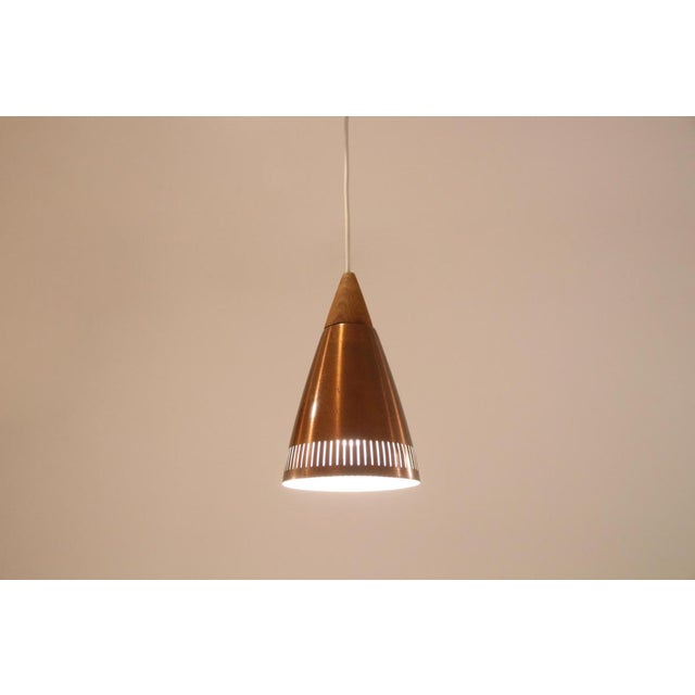 Beautiful Danish design cone lamp in the style of Bent Karlby for LYFA. The lamp is made of a perforated copper shade with...