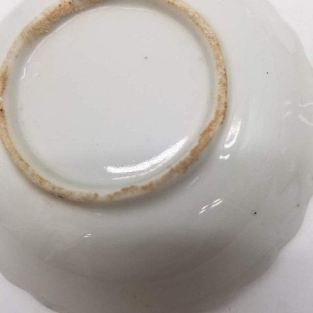 This traditional Japanese set consists of small blue and white ceramic dishes crafted using classic underglaze cobalt...