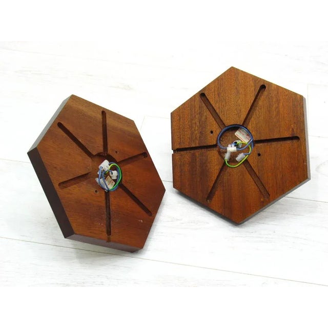 Holded wall lamps made of wood and brass, 1970/80. Set of 2. European Plug (up to 250V).The wiring of this item may be...