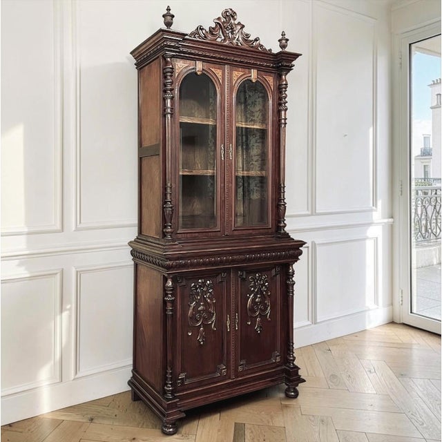 Richly carved and exceptionally well proportioned, this 19th century French Napoleon III bibliothèque reflects the...