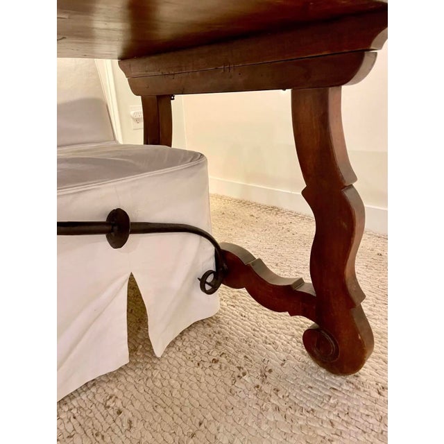 An exceptionally pretty, antique walnut trestle table from the early 1900s. Sturdy top with a beautiful patina and lovely...
