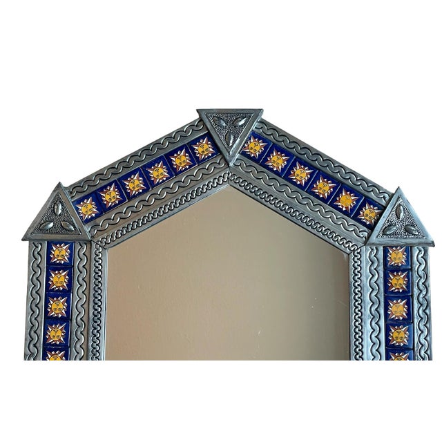The Mexican Punched Tin Talavera Tile Mirror is a beautiful and authentic piece of folk art handmade in Mexico. The mirror...