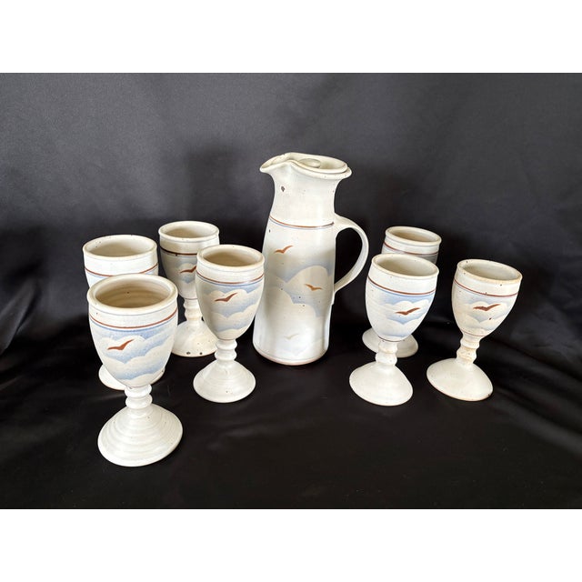 This is a beautiful set of handmade pottery. It is rare full drink set that includes a large lidded pitcher SEVEN stemmed...