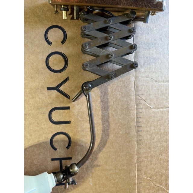 Small wall mounted sconce that is adjustable. Wired for easy plug in. Nice reading light for a bed.