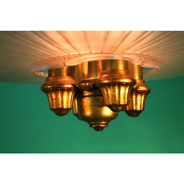 Lightolier refers to this fixture as a Dinolier in their 1928 catalog. It has a striking huge glass shade with a textured...