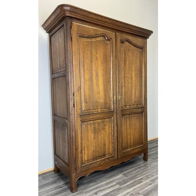 This Vintage French Louis–style wardrobe presents a handsome and timeless presence, crafted in oak with a rich warm...