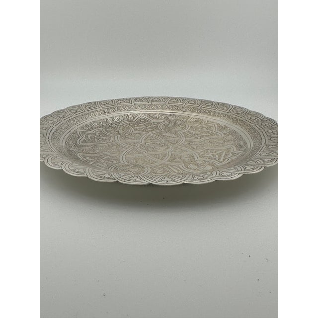This Egyptian solid silver tray features intricate hand-engraved Islamic designs and a beautifully scalloped rim. The tray...
