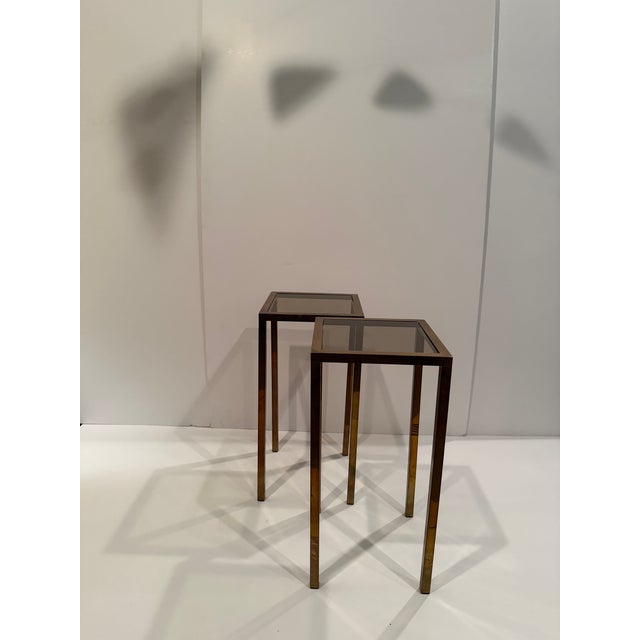 Pair of mid-century modern high aged brass & Smokey glass end tables or plant stands. Great for display.
