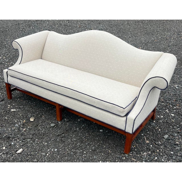 Classic Chippendale style camelback sofa by Ethan Allen The rich cherry Chippendale legs and stretchers contrast with the...