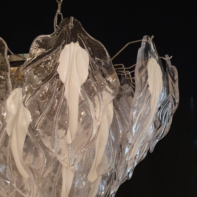 This chandelier is made of handmade murano glass leaves, crafted from crystal with a milky white core. This vintage-style...