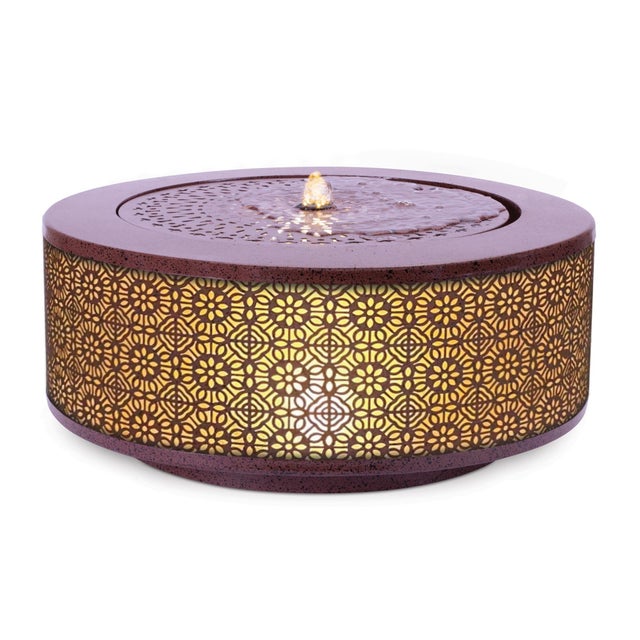 Create a relaxing atmosphere with this Illuminated Round Tabletop Fountain. Featuring a decorative patterned metal base...