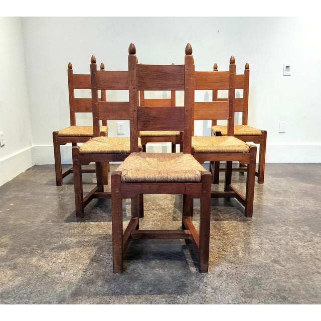 Minimal Mid-Century carved oak Belgian dining chairs with rush seats. Lovely blend of minimal modern design and heavy,...
