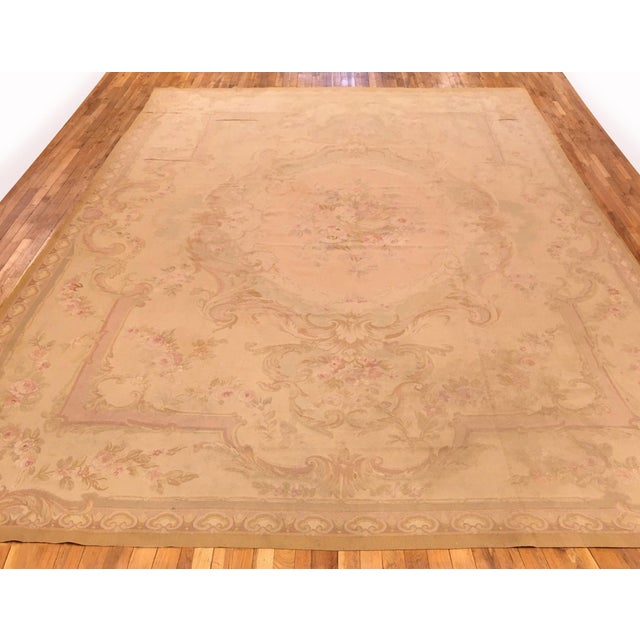 An antique French Aubusson carpet, size 14'0 x 9'10, circa 1890. This fine Louis Philippe era flat-woven wool carpet...