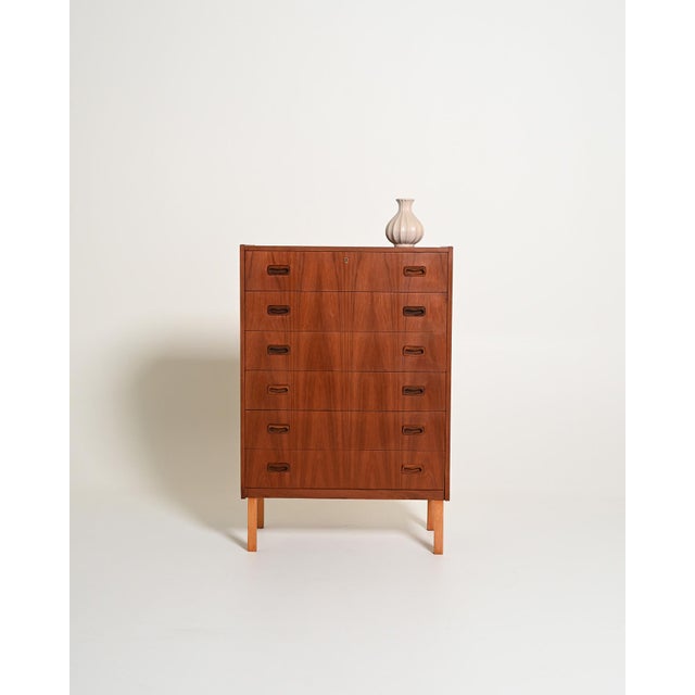Teak frame with six drawers and carved solid wood handles, with square oak legs. Scandinavian production, 1960s....