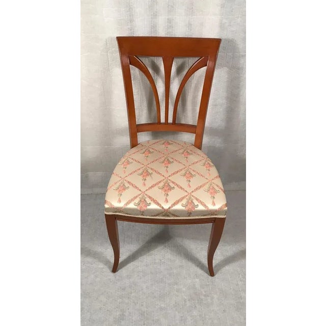 Set of four Biedermeier Style Dining Chairs. Pretty backrest decor and very decorative fabric. In very good condition.