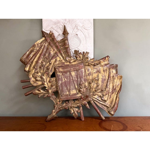 A beautiful French carved-wood wall plaque depicting military symbols. Carved wooden plaques like these were popular wall...