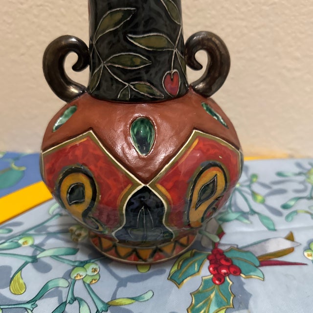 Add a touch of bohemian elegance to your home decor with this striking vintage studio art pottery vase. Featuring a...