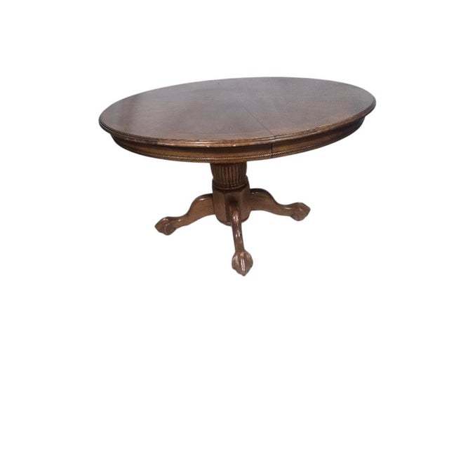 Classic vintage solid oak dining table featuring an elegant claw foot pedestal base and a beautiful quarter-sawn oak...