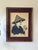 Pair of vintage framed textile artworks depicting expressive Asian figures engaged in traditional crafts. Lightweight.