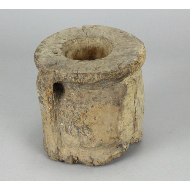 An impressive antique primitive vessel An early mortar with handle, heavy and imposing All carved by hand from a single...