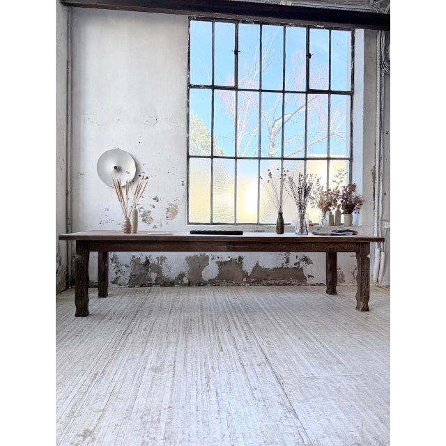 Antique, very large solid oak farmhouse table from the 20th century. we love its xl size, the wood's natural beauty, and...