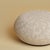 The Kuna is an upholstered oak pouf, Dedar Ur drawn over a frame of solid smoked oak. It brings textile and give to a...