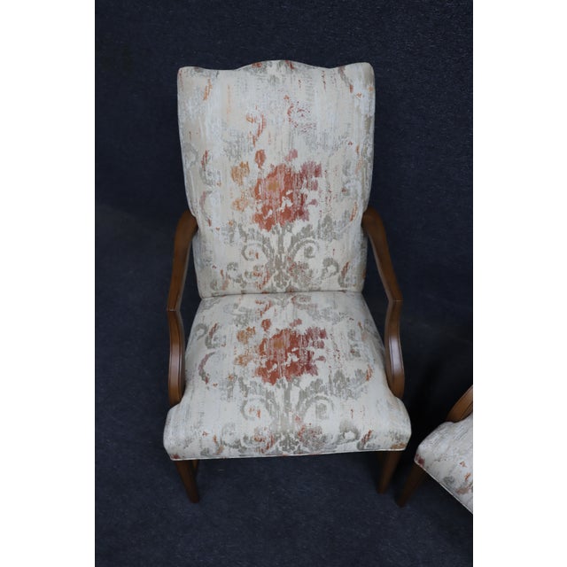 Pair of Ethan Allen lolling chairs with cherry wood frames and curved arms. Upholstered in a neutral fabric with a muted...