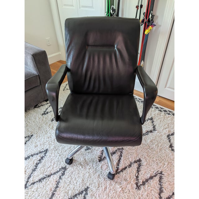 Authentic Poltrona Frau Forum Executive office chair upholstered in espresso Pelle Frau leather, with a polished aluminum...