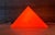Postmodern prism-shaped floor/table lamp by Heico. Shown here in orange. These lamps feature the graphic form of a prism....