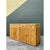 This vintage stacked rattan credenza is entirely clad in densely arranged bundles of natural rattan poles, their vertical...