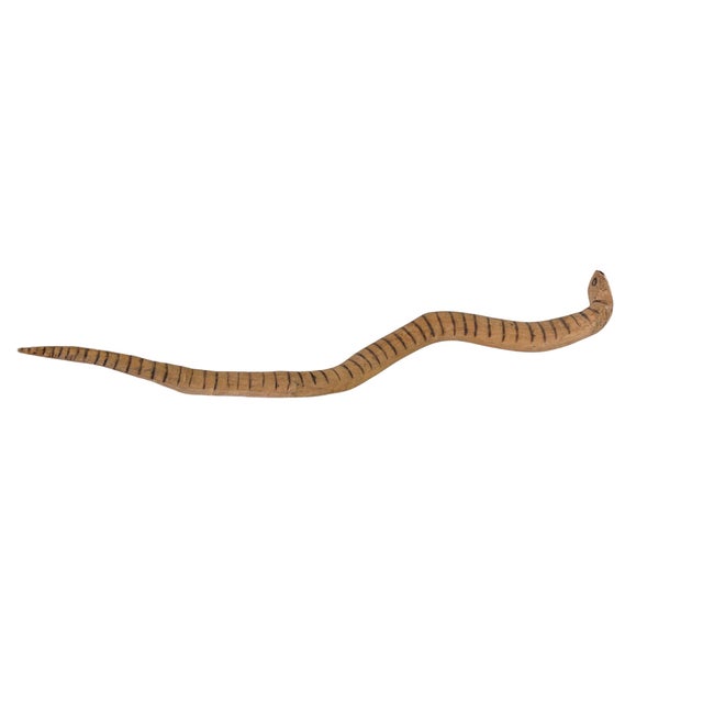 Vintage tribal hand-carved wooden sculpture of a snake from Papua New Guinea, fashioned from light-brown wood with...