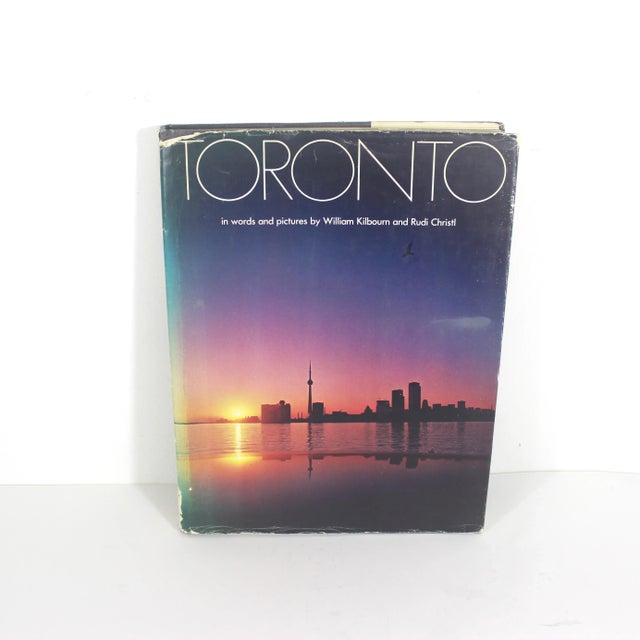 Large coffee table book with a charcoal grey linen hard cover. Also has its dust jacket.