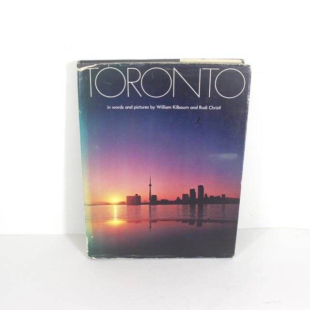 Large coffee table book with a charcoal grey linen hard cover. Also has its dust jacket.