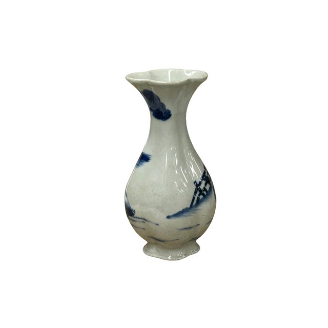 This small blue and white porcelain vase features a charming lobed, foliate rim that mimics the shape of a flower,...