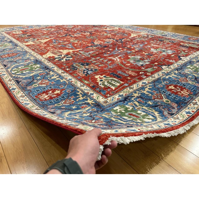This handmade Persian Bidjar-style rug showcases a bold tribal pattern with deep red, ivory, green, and blue tones. Known...