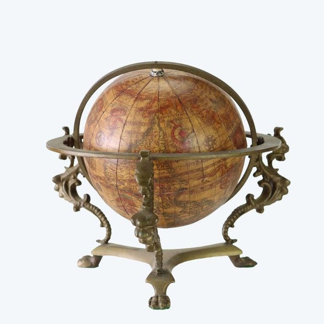 An antique Italian desk globe, dating to the 19th century, featuring an 'Old World' style map and presented on a...