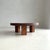 An artisan 1970s solid oak coffee table featuring a thick, sculptural tabletop supported by three rustic legs. Slightly...