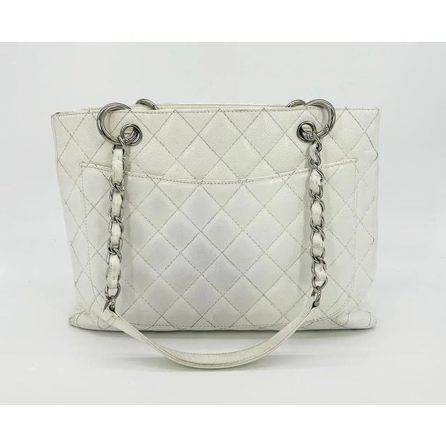 Chanel Quilted White Caviar Grand Shopper Tote in fair condition. Quilted white caviar leather exterior trimmed with...