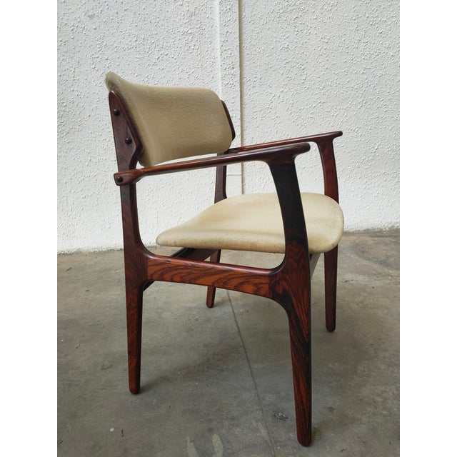 This set of ten modern Danish dining chairs is attributed to the renowned designer Erik Buch. with their gracefully curved...