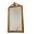 Antique Louis Philippe floor mirror made of gold-painted pine, featuring a charming floral cartouche at the top and a...