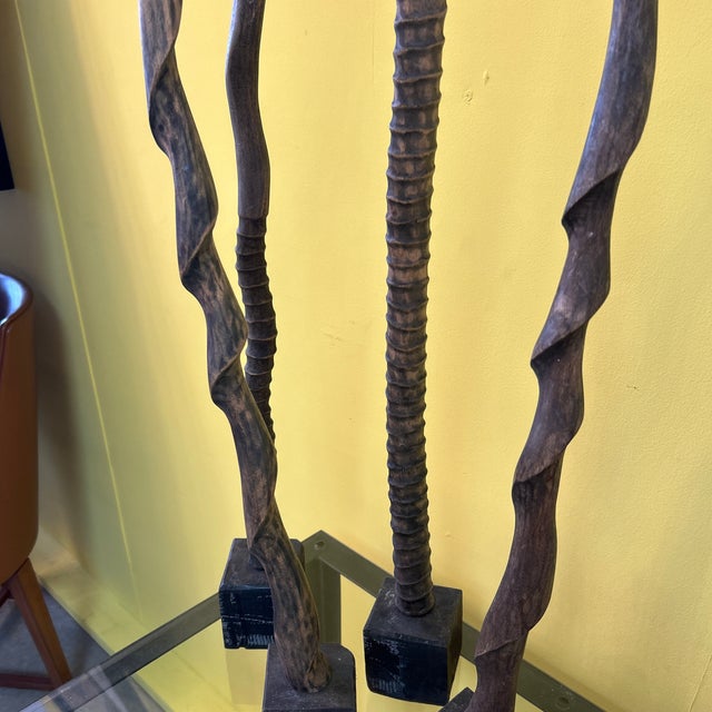 Tall slender sinuous 4-part forms carved of wood resembling exaggerated antlers and natural horn structures. Mounted on...