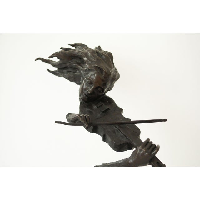 This beautiful modern work sculpture signed S. Dali captures a musician in a striking, almost impossible pose, combining...