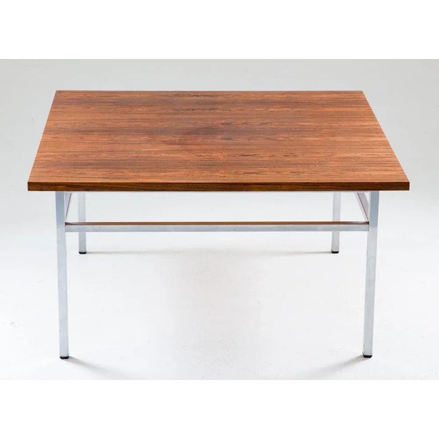 Beautiful rosewood and steel coffee table by Karl-Erik Ekselius for Troeds, Sweden The table consists of a square rosewood...
