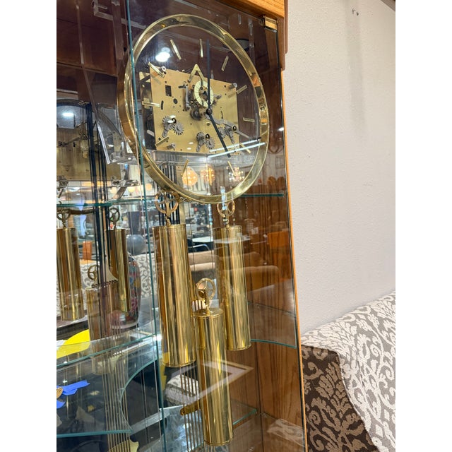 A beautifully crafted Howard Miller curio clock featuring a warm wood finish and glass-paneled cabinet. Designed to...