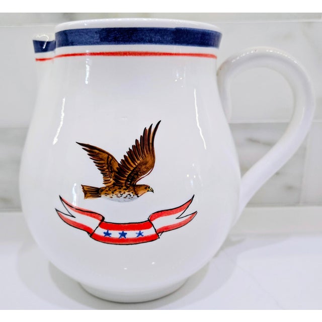 Hand-painted Italian pottery pitcher featuring a soaring eagle and patriotic red, white, and blue banner, perfect as a...
