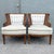 Elegant pair of vintage Hollywood Regency barrel chairs featuring warm wood frames, gracefully curved silhouettes, and...