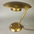 Italian table lamp with a classic and elegant 1950s design. Brass structure with adjustable arm, shade, and plate. Good...