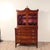 A good Federal period neoclassical mahogany desk with upper glazed bookcase. The writing surface folds open resting on two...