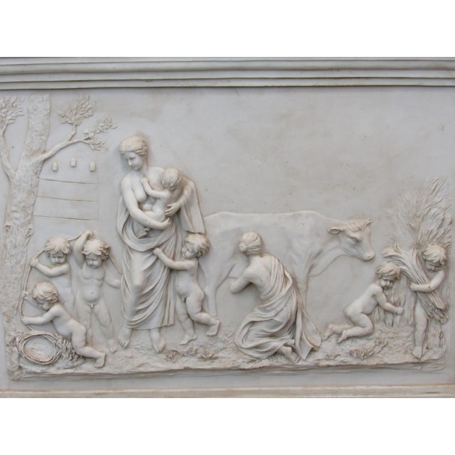 A dramatic vintage Neoclassical-style architectural panel featuring an elaborate raised figural scene surrounded by...